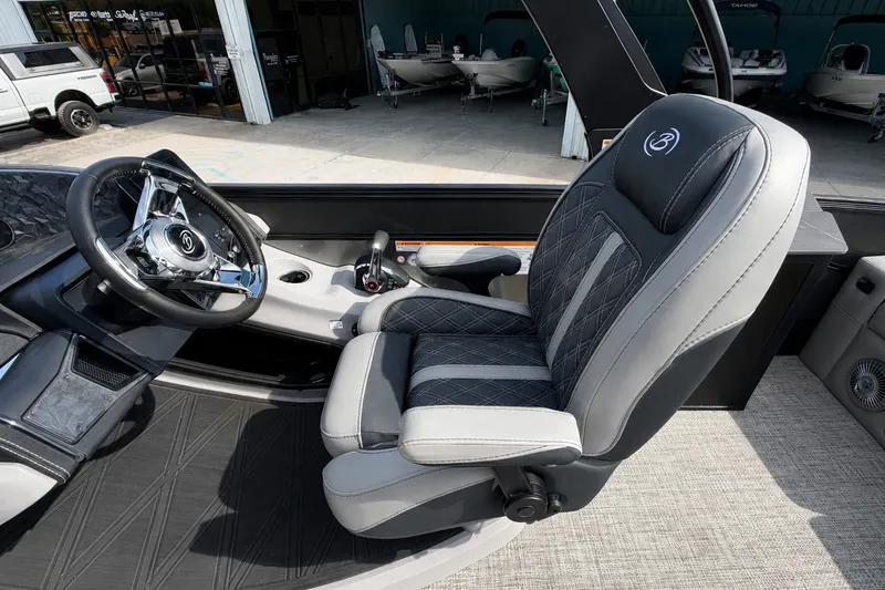 Slide: The Image of Captain's seat and steering wheel of 2026 Barletta Lusso 25UE pontoon boat. - 25
