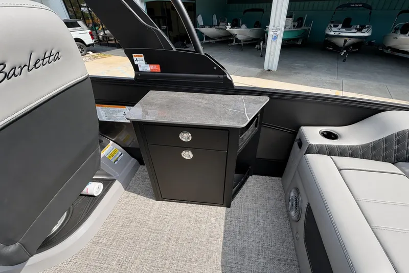 Slide: The Image of Interior of 2026 Barletta Lusso 25UE boat with seating and storage cabinet. - 30