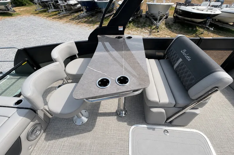 Slide: The Image of 2026 Barletta Lusso 25UE boat interior with elegant seating and modern table design. - 27