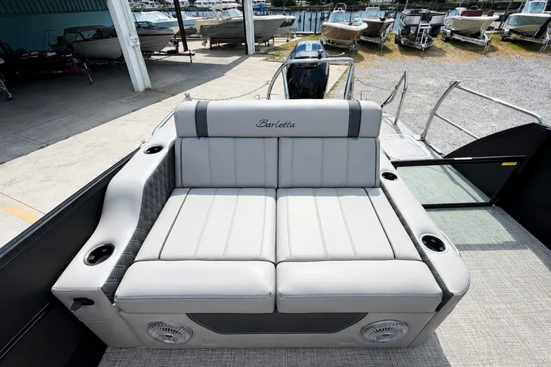 Slide: The Image of 2026 Barletta Lusso 25UE boat interior with luxurious seating and cup holders. - 29