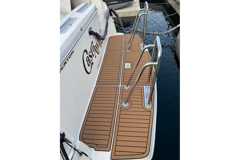 Slide: The Image of 2000 Silverton 330 Sport Bridge swim platform with teak-style decking and stainless steel rails. - 8