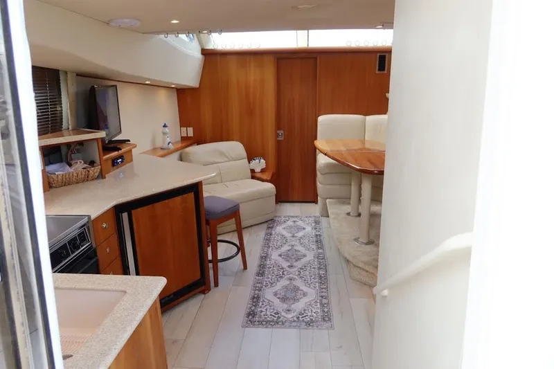Slide: The Image of Interior of 2000 Silverton 330 Sport Bridge yacht with modern furnishings and cozy seating area. - 9
