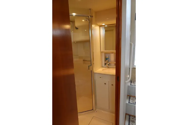 Slide: The Image of Bathroom interior of 2000 Silverton 330 Sport Bridge yacht, featuring sink and shower. - 13