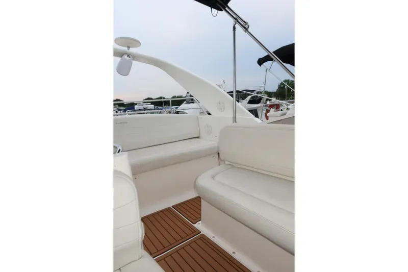 Slide: The Image of Interior view of 2000 Silverton 330 Sport Bridge with white seating and wooden flooring. - 18