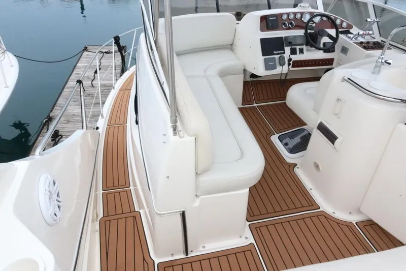 Slide: The Image of 2000 Silverton 330 Sport Bridge interior with teak flooring and white seating. - 20