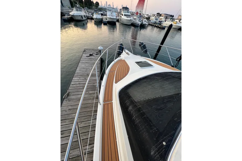 Slide: The Image of 2000 Silverton 330 Sport Bridge docked at marina, surrounded by boats. - 4