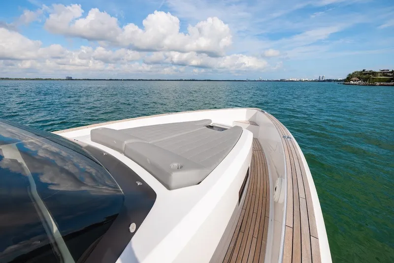 Slide: The Image of Luxurious 2021 Pardo Yachts P38 cruising on serene blue waters under a cloudy sky. - 31