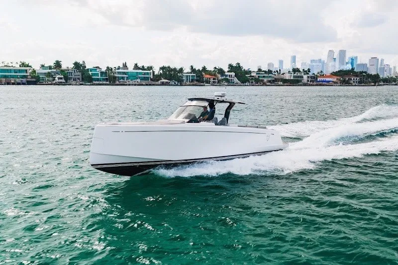 Slide: The Image of 2021 Pardo Yachts P38 cruising on water with city skyline in background. - 15