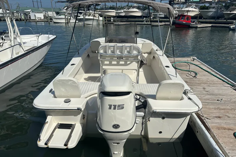 Slide: The Image of 2021 Savannah SS21 boat docked, featuring a 115 horsepower outboard motor. - 23