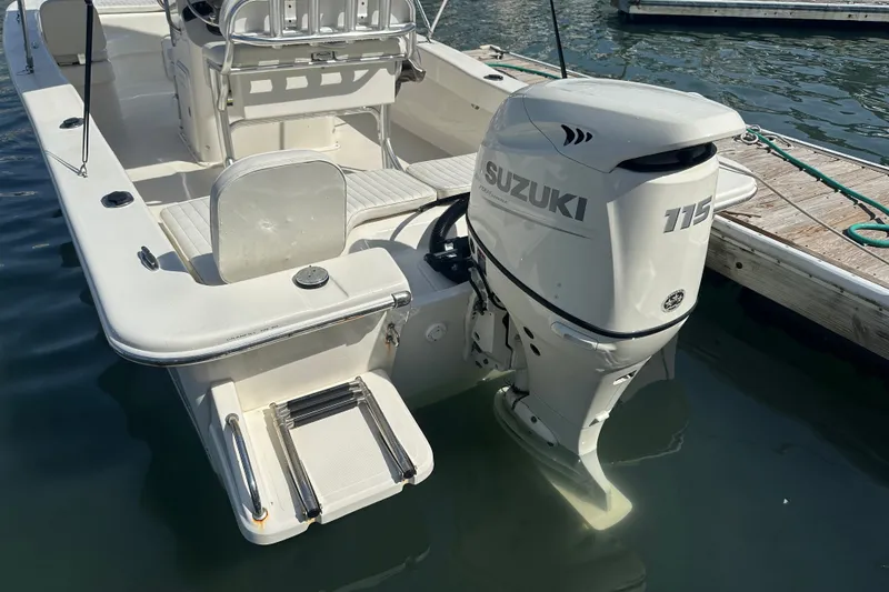 Slide: The Image of 2021 Savannah SS21 boat with Suzuki 115 outboard motor docked at marina. - 24