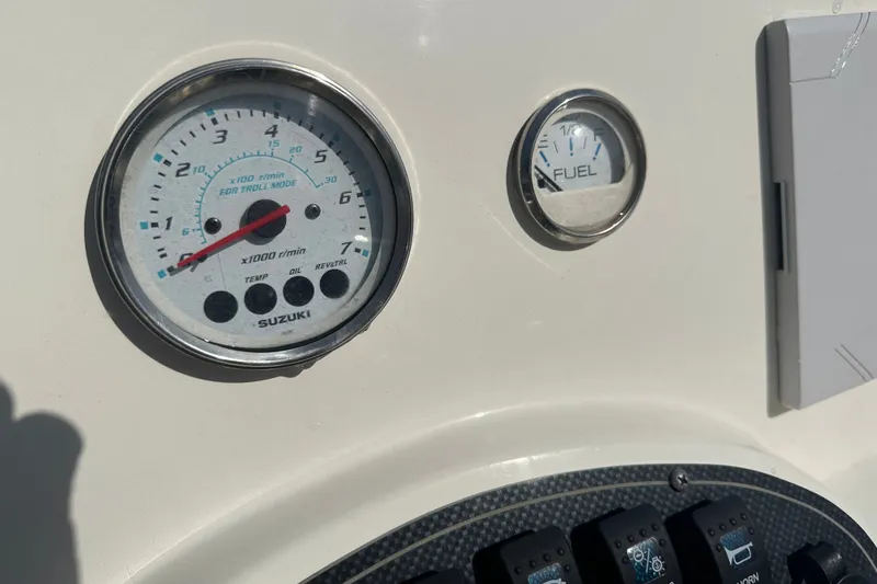 Slide: The Image of Dashboard of a 2021 Savannah SS21 boat with Suzuki tachometer and fuel gauge. - 16