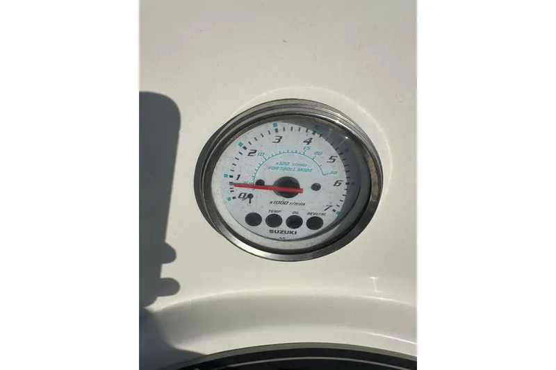Slide: The Image of Tachometer on a 2021 Savannah SS21 boat, displaying RPM and Suzuki branding. - 21