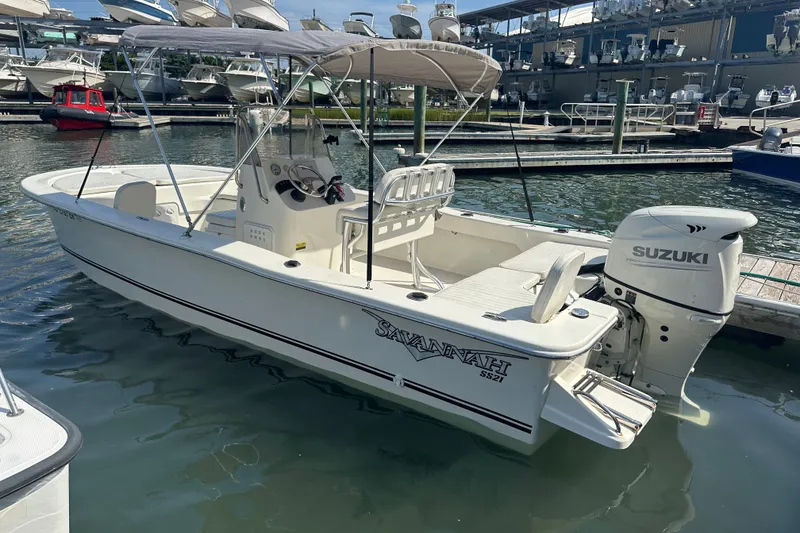 Slide: The Image of 2021 Savannah SS21 boat with Suzuki engine docked at marina. - 25