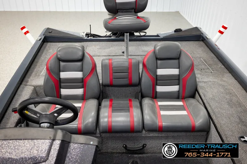 Slide: The Image of 2021 Ranger RT188C boat interior with gray and red seating, steering wheel, and carpeted floor. - 19