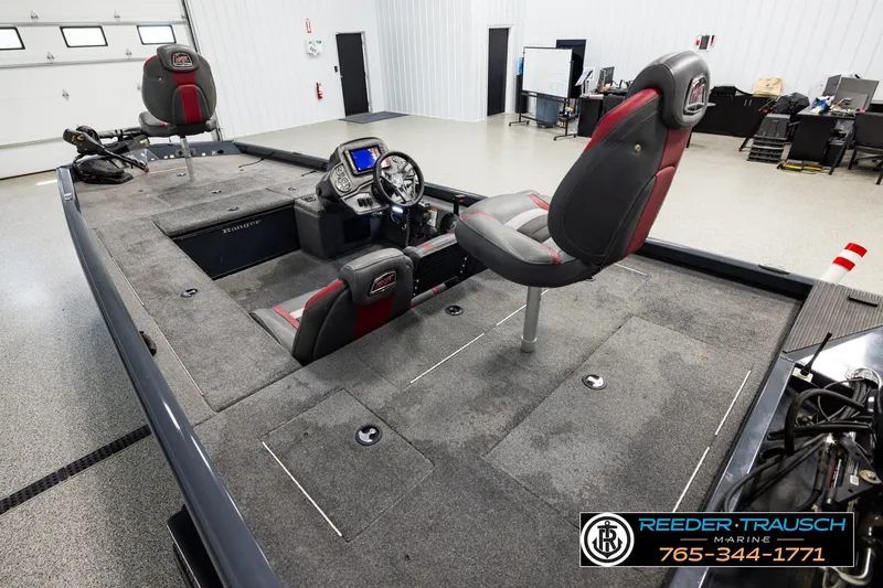 Slide: The Image of 2021 Ranger RT188C fishing boat interior with seating and control panel in showroom. - 9