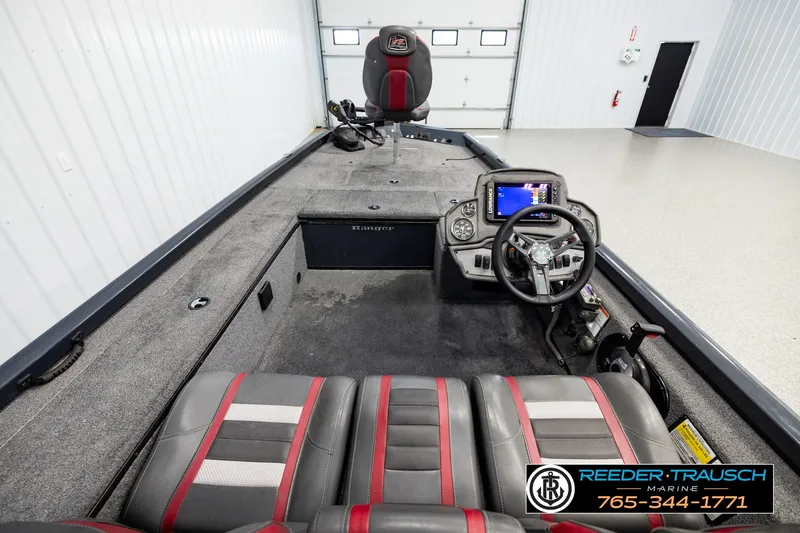 Slide: The Image of 2021 Ranger RT188C boat interior with steering console and seating in showroom. - 11