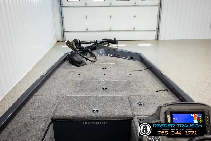 Slide: The Image of 2021 Ranger RT188C boat interior with fishing equipment in a garage setting. - 22