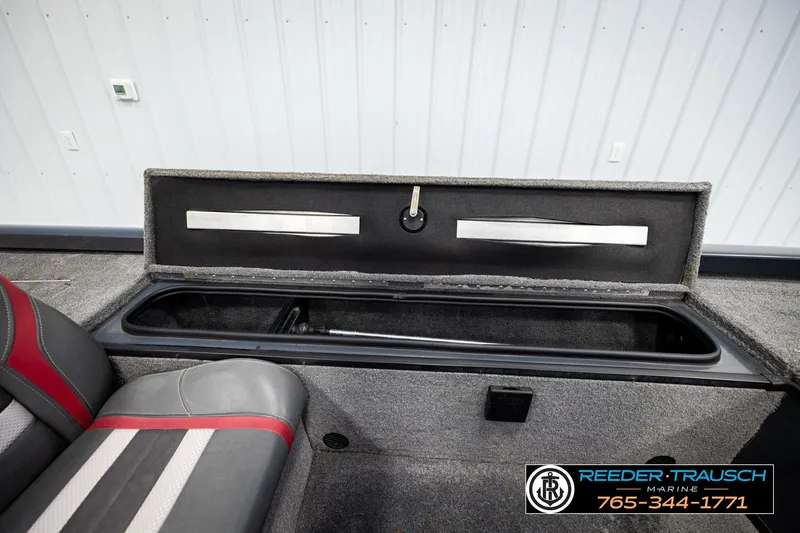 Slide: The Image of 2021 Ranger RT188C boat storage compartment with open lid, showcasing interior space and seating. - 26