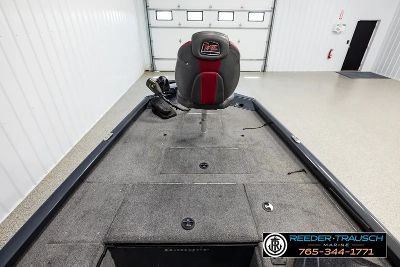 Slide: The Image of 2021 Ranger RT188C boat interior with fishing seat in a garage setting. - 13