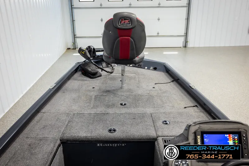 Slide: The Image of 2021 Ranger RT188C fishing boat interior with seat and control panel in a garage. - 23