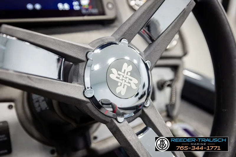 Slide: The Image of Steering wheel of 2021 Ranger RT188C boat with logo, featuring Reeder Trausch Marine contact details. - 29