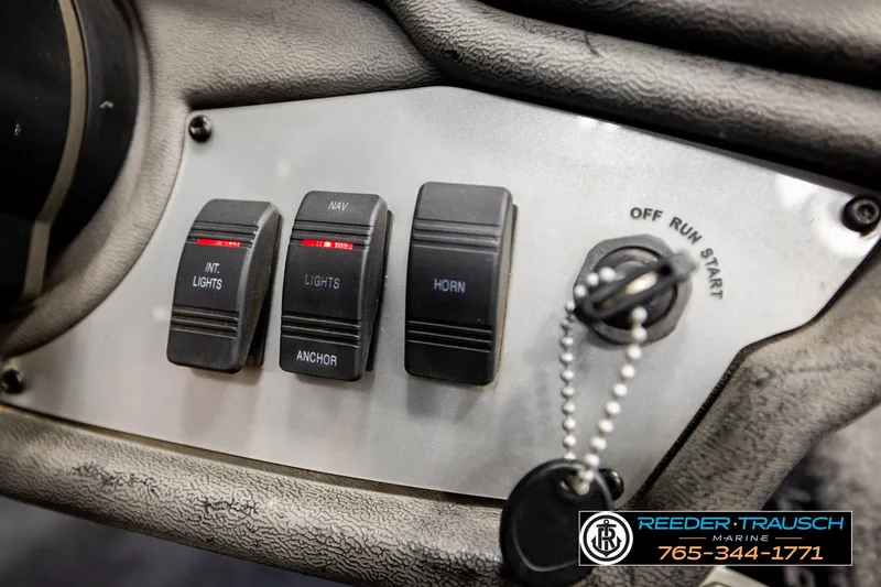 Slide: The Image of Control panel of a 2021 Ranger RT188C boat with switches and ignition key. - 34