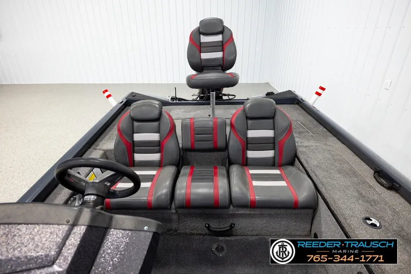 Slide: The Image of 2021 Ranger RT188C boat interior with gray and red seating, steering wheel, and carpeted floor. - 15