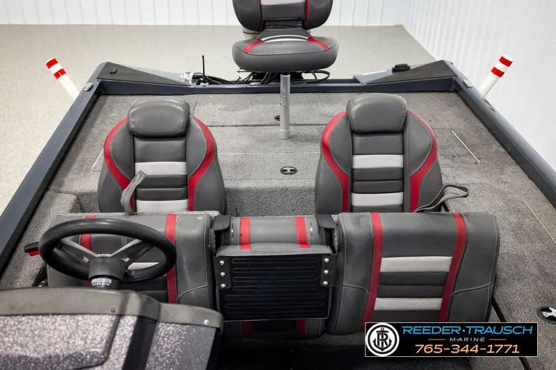 Slide: The Image of 2021 Ranger RT188C boat interior with gray and red seating, steering wheel, and console. - 21