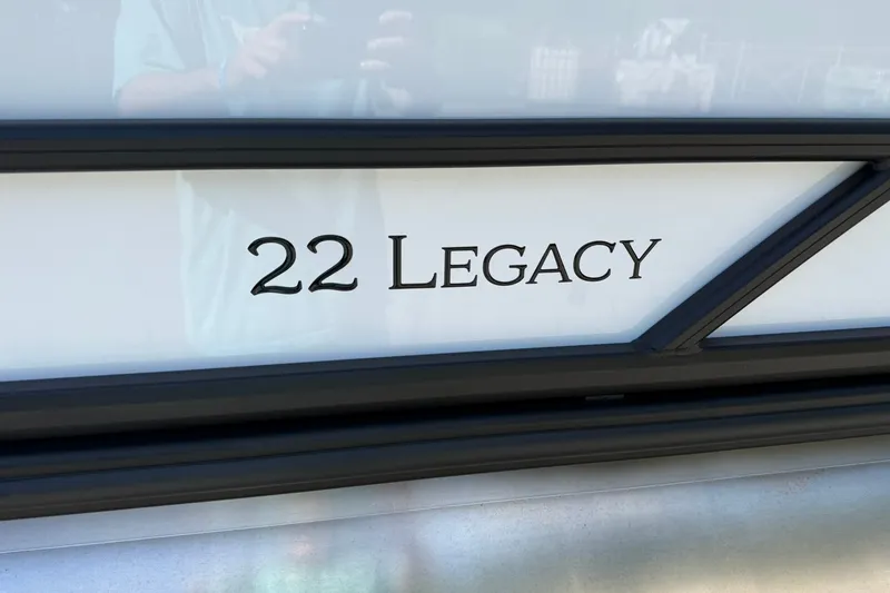 Slide: The Image of Close-up of 2026 Bentley Pontoons Legacy 223 Swingback logo on boat exterior. - 21