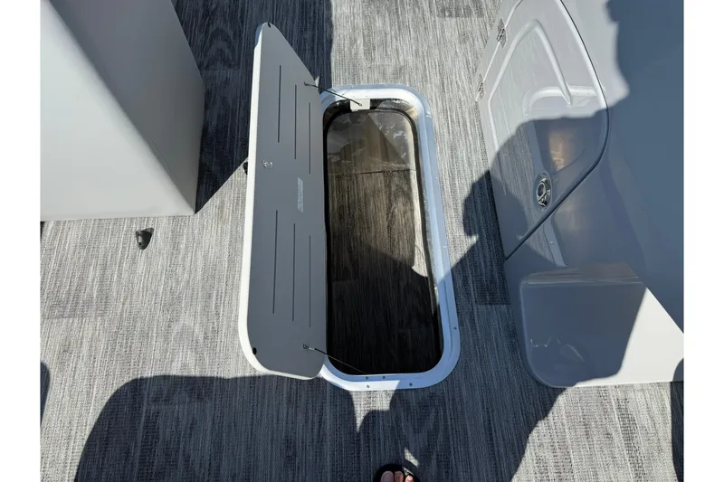 Slide: The Image of Open storage compartment on 2026 Bentley Pontoons Legacy 223 Swingback boat deck. - 14