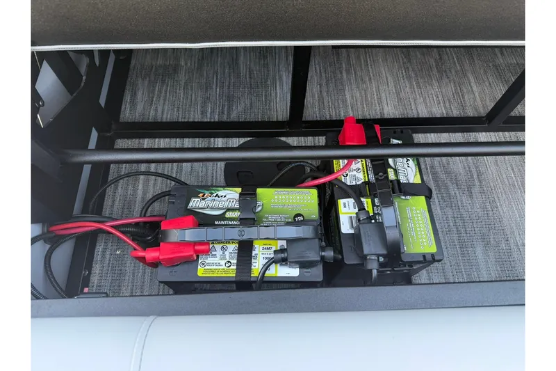 Slide: The Image of Battery compartment of 2026 Bentley Pontoons Legacy 223 Swingback, featuring dual marine batteries. - 11