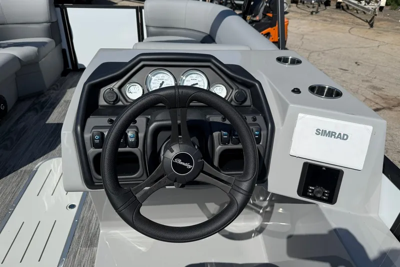Slide: The Image of 2026 Bentley Pontoons Legacy 223 Swingback dashboard with steering wheel and Simrad display. - 5