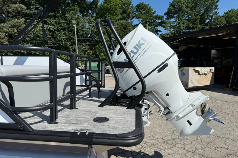 Slide: The Image of 2026 Bentley Pontoons Legacy 223 Swingback with Suzuki outboard motor, docked outdoors. - 20
