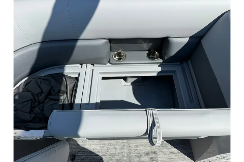 Slide: The Image of Interior storage compartment of 2026 Bentley Pontoons Legacy 223 Swingback with cup holders. - 10