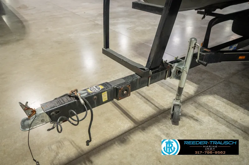Slide: The Image of Trailer hitch of a 2000 Bennington 227L boat on display indoors. - 53