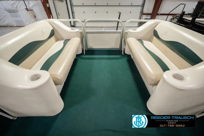 Slide: The Image of Interior of a 2000 Bennington 227L pontoon boat with green and beige seating. - 25