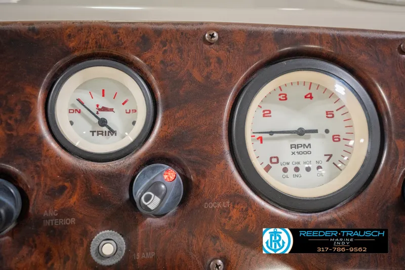 Slide: The Image of Dashboard of a 2000 Bennington 227L boat with trim and RPM gauges. - 38