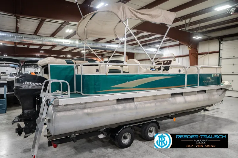 Slide: The Image of 2000 Bennington 227L pontoon boat with Johnson outboard motor in indoor showroom. - 8