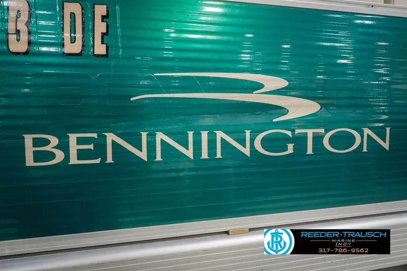 Slide: The Image of Bennington 227L 2000 model boat with teal exterior and logo, Reeder-Trausch Marine branding. - 52