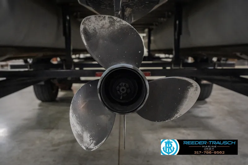 Slide: The Image of Close-up of a boat propeller on a 2000 Bennington 227L, displayed indoors. - 51