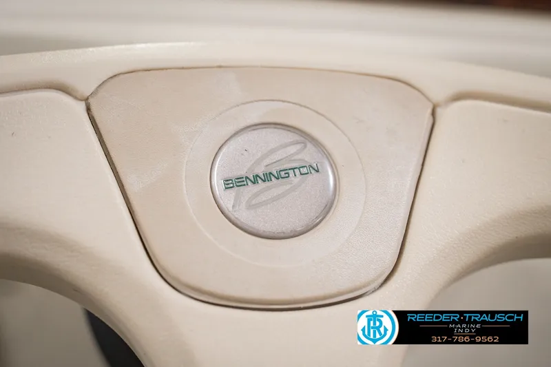 Slide: The Image of Steering wheel of a 2000 Bennington 227L boat with logo detail. - 35