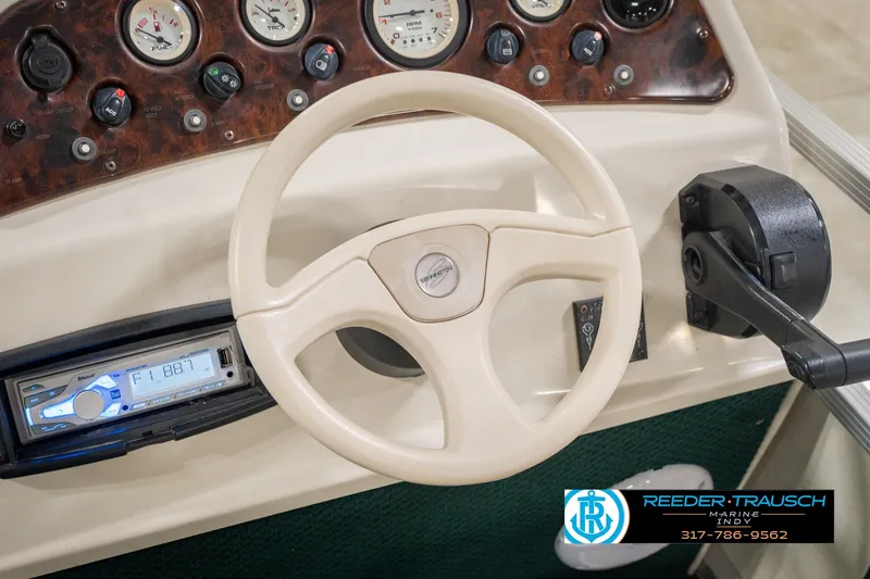 Slide: The Image of Steering console of a 2000 Bennington 227L boat with gauges and controls. - 34