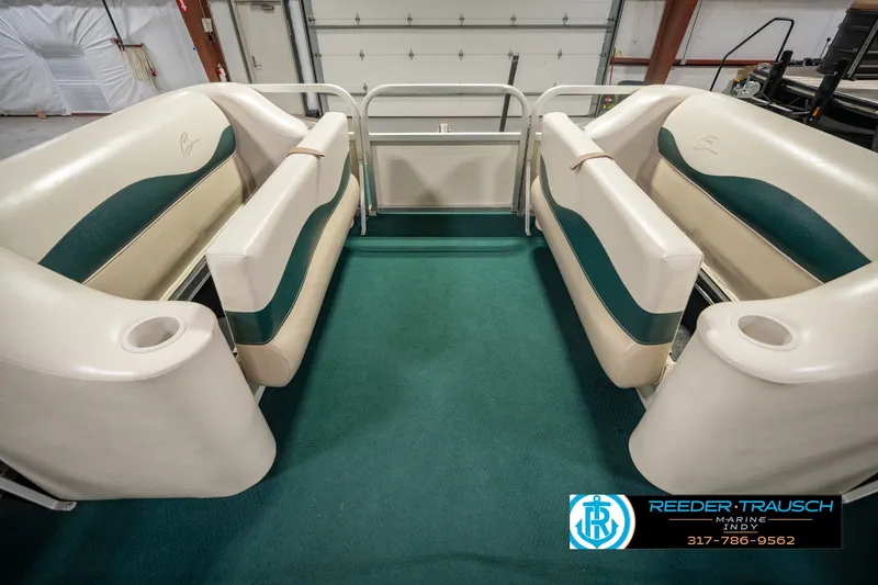 Slide: The Image of Interior of a 2000 Bennington 227L pontoon boat with green and beige seating. - 26