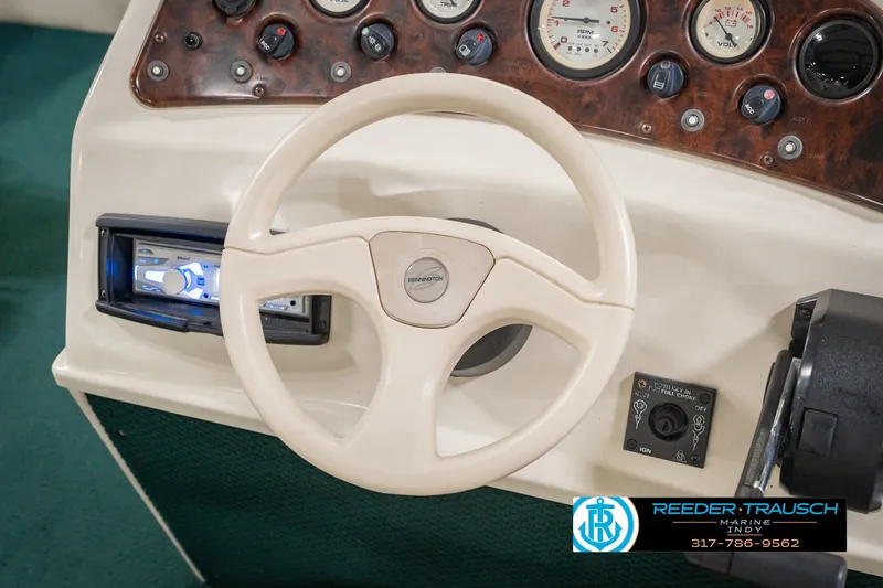 Slide: The Image of Steering wheel and dashboard of a 2000 Bennington 227L boat with control panel. - 33