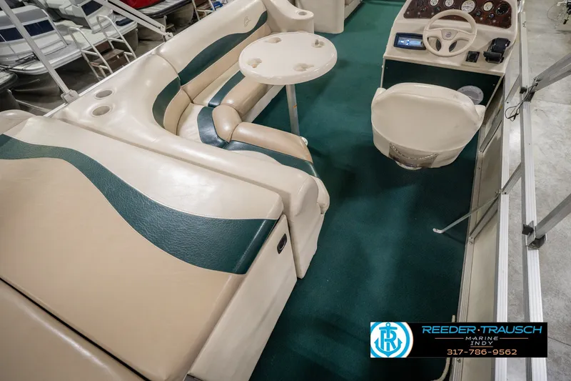 Slide: The Image of Interior of a 2000 Bennington 227L boat with seating and steering console. - 16