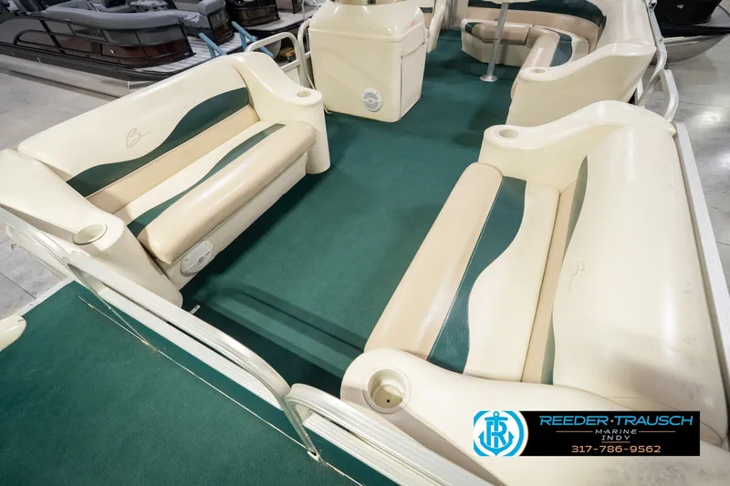 Slide: The Image of Interior of a 2000 Bennington 227L pontoon boat with green and beige seating. - 13