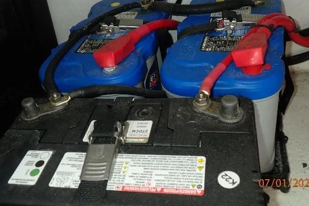 Slide: The Image of Batteries connected with cables in a 2023 Cape Horn 34XS boat. - 54