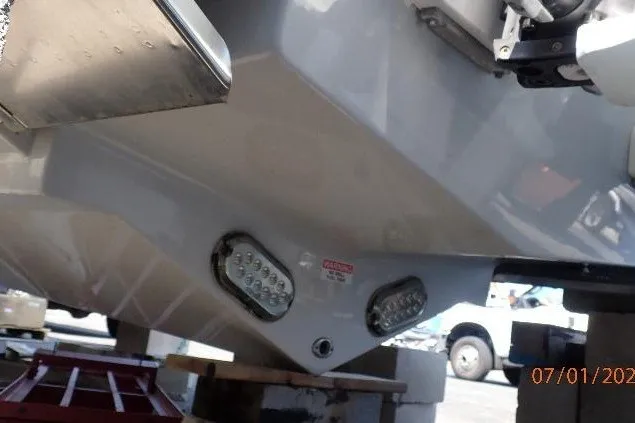 Slide: The Image of 2023 Cape Horn 34XS boat hull with underwater lights in a marina setting. - 16