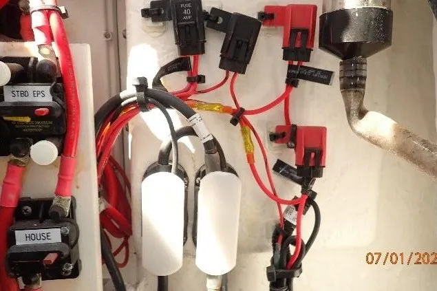 Slide: The Image of Electrical wiring and fuses inside a 2023 Cape Horn 34XS boat. - 31