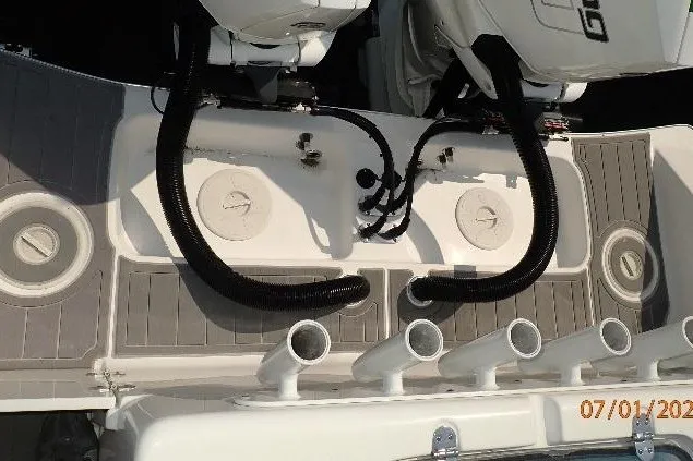 Slide: The Image of 2023 Cape Horn 34XS boat deck with dual engines and rod holders. - 24